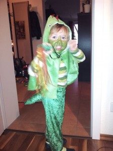 In his right had Lukey holds a green tube lovingly tacked to nylon ribbons to suggest a fire-breathing dragon